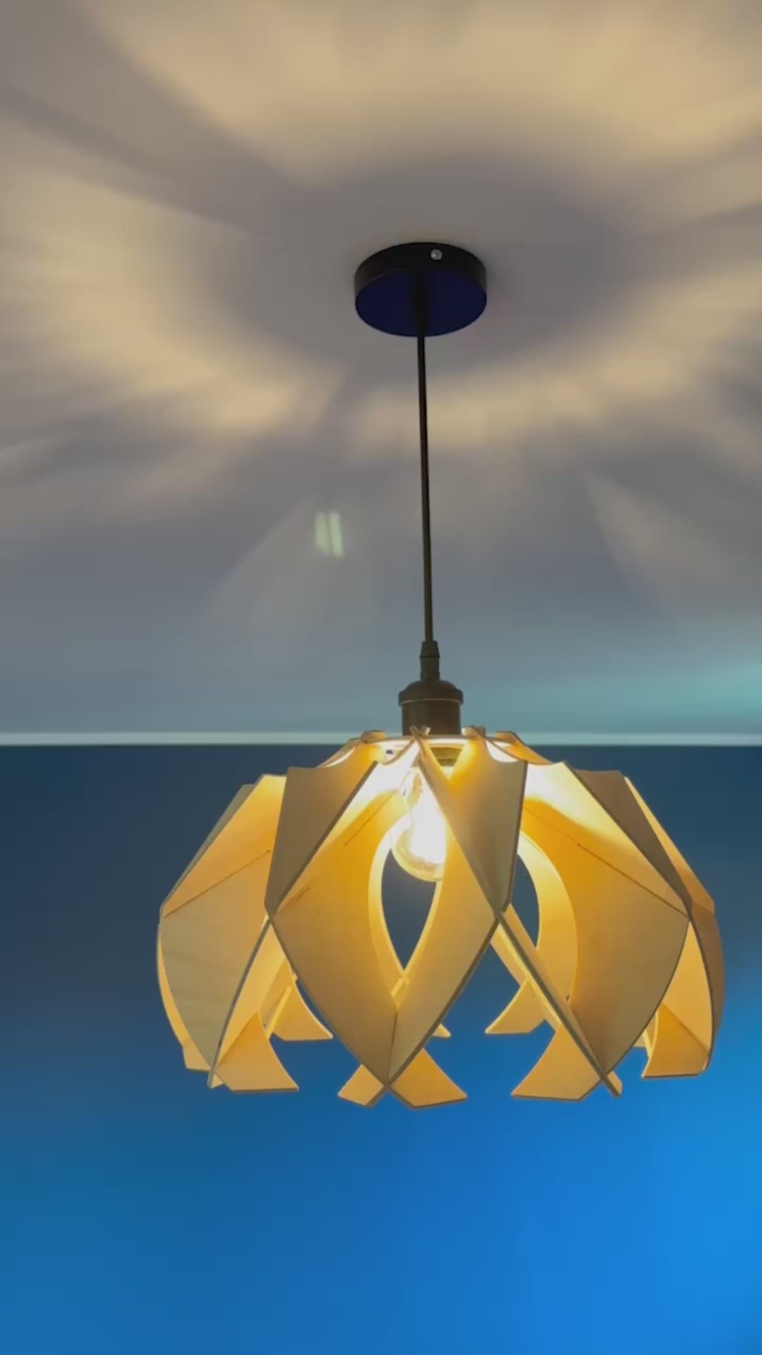 Short video showcasing different views of handcrafted medium wooden pendant lamps with a modern flower-like design, highlighting the intricate craftsmanship, eco-friendly materials, and the beautiful light patterns they create.