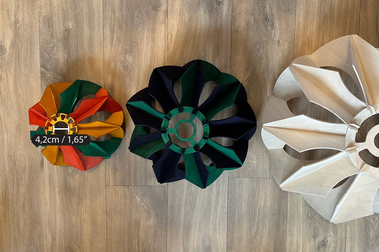 Top-down view of three pendant lamps of varying sizes, with the smallest stained in green, yellow ochre, and scarlet, displaying the flower-like design and the central opening, with the small one having a 4.2cm (1.65&quot;) diameter hole.